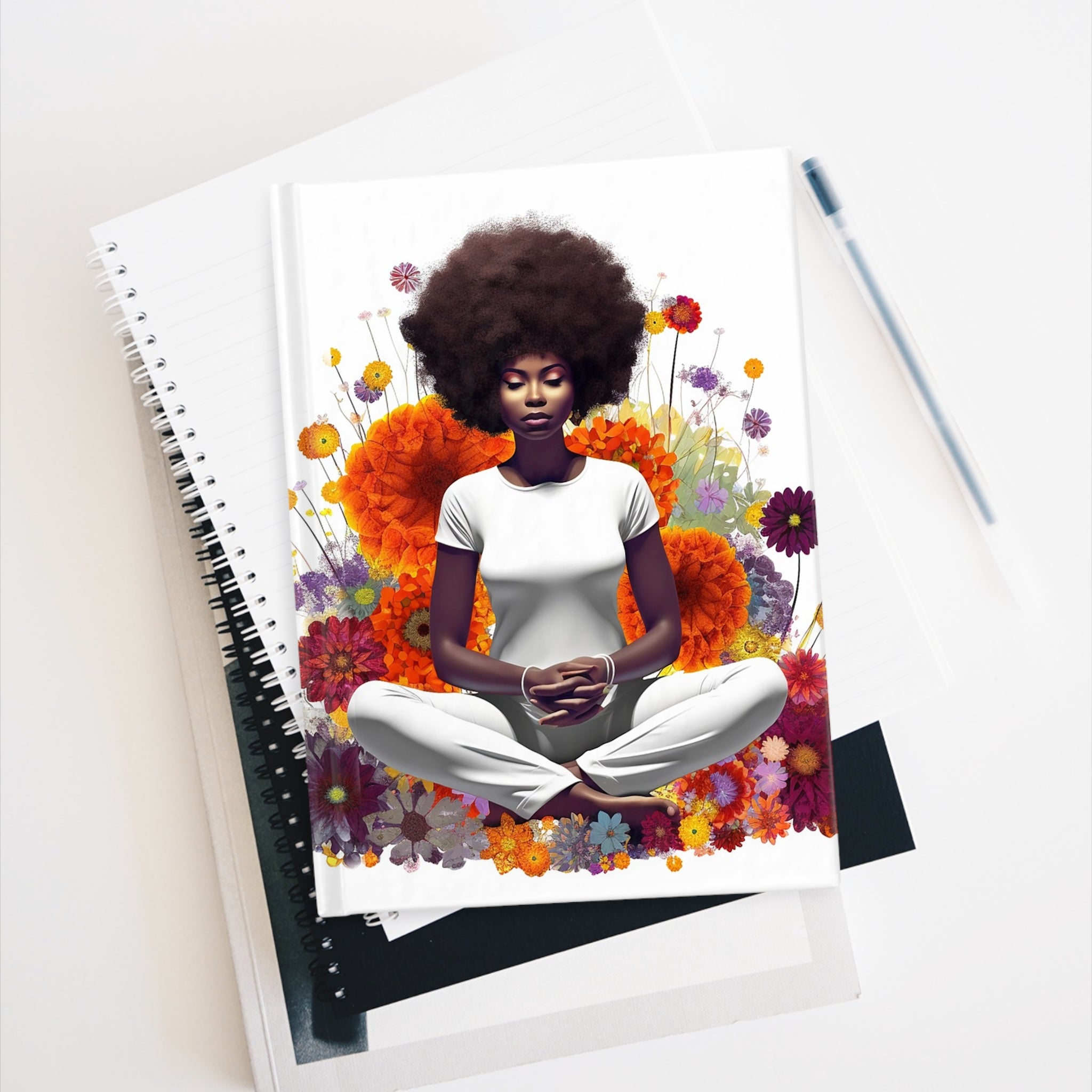 Black Woman Yoga Pose Journal featuring an African American woman meditating in a field of wildflowers. A perfect gift for yogis, wellness lovers, and mindfulness journaling.