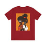 Two Black Women silhouette wearing fashionable eyewear on an orange background, featured on an Afrocentric unisex tee shirt