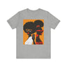 They Not Like Us Tee Shirt featuring two Black women in silhouette wearing high-fashion eyewear, holding a cell phone with the phrase "They Not Like Us" on an orange background – Afrocentric unisex apparel.