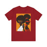 They Not Like Us Tee Shirt featuring two Black women in silhouette wearing high-fashion eyewear, holding a cell phone with the phrase "They Not Like Us" on an orange background – Afrocentric unisex apparel.