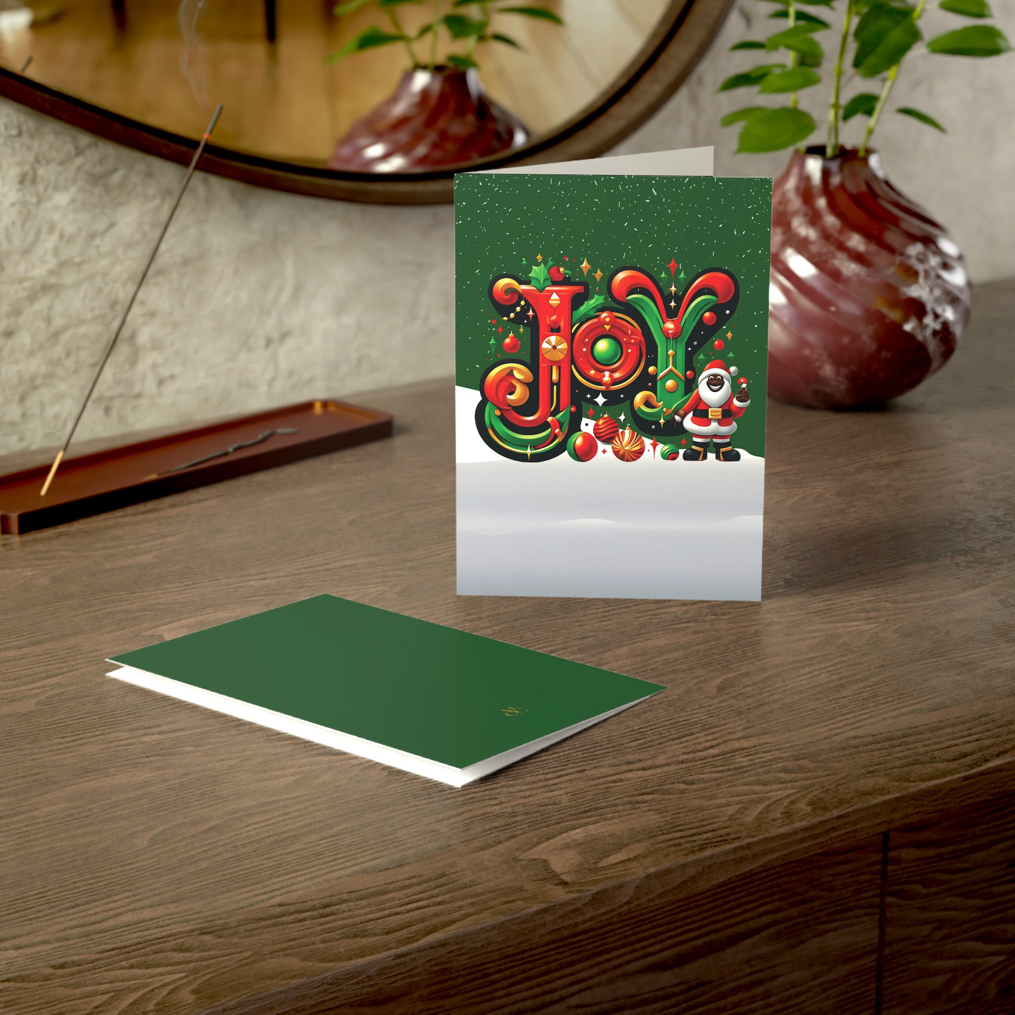 Black Santa Christmas Card featuring African American Santa Claus with the word “JOY,” Afrocentric holiday greeting card available as single or multipack with envelopes.