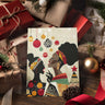 African American Women Christmas Carolers Greeting Card featuring Afrocentric holiday artwork of Black women singing Christmas carols in vibrant seasonal colors.