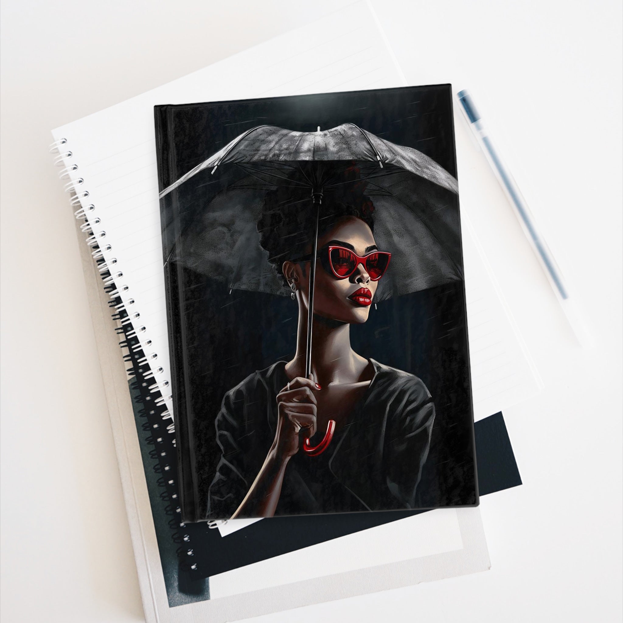 Black Woman Fashionista Journal featuring a mysterious African American woman with bold red lipstick, trendy red sunglasses, and a black umbrella in stormy weather. A stylish memory journal for fashion lovers and writers.