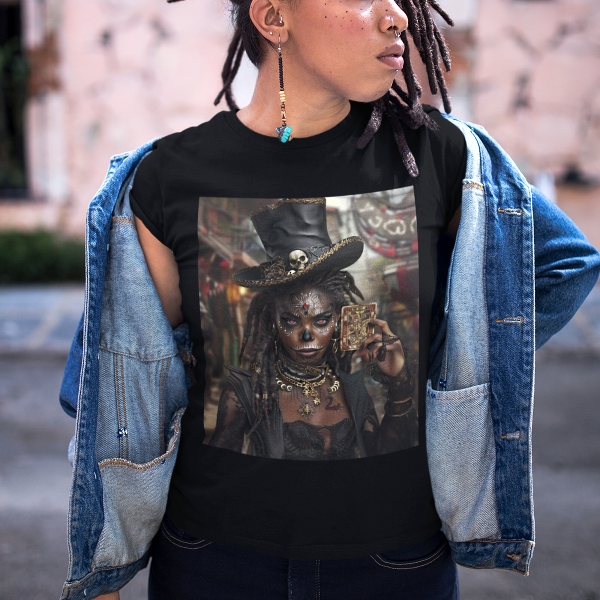 Voodoo Priestess Tee Shirt featuring Afrocentric gothic artwork of a woman with skull face paint, red eyes, and holding a tarot card. Dark fantasy Afrocentric graphic tee for mysticism, culture, and streetwear fashion.