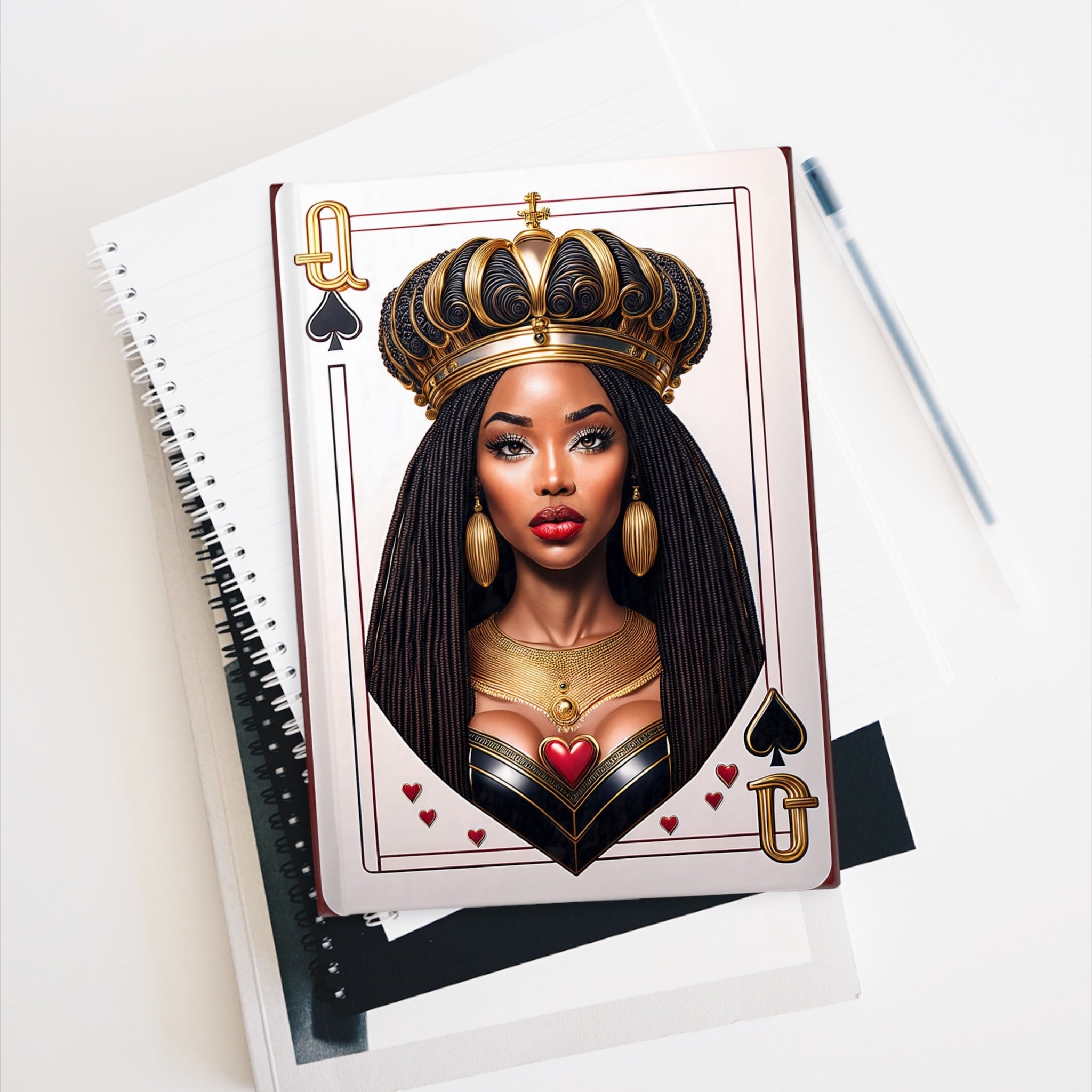 Black Queen of Spades Journal featuring an African American woman with a gold crown, inspired by royalty and empowerment. Afrocentric notebook available with blank or ruled line pages, perfect for sketching, writing, or daily journaling.