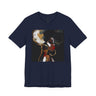 A navy blue short-sleeve crewneck t-shirt featuring a square graphic print of an abstract portrait of a Black woman with gold hoop earrings, red lips, and a large white hat, displayed on a solid white background.