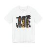 A white short-sleeve crewneck t-shirt featuring a graphic print of the word 'JUSTICE' filled with stylized illustrations of faces in black, brown, and orange tones.