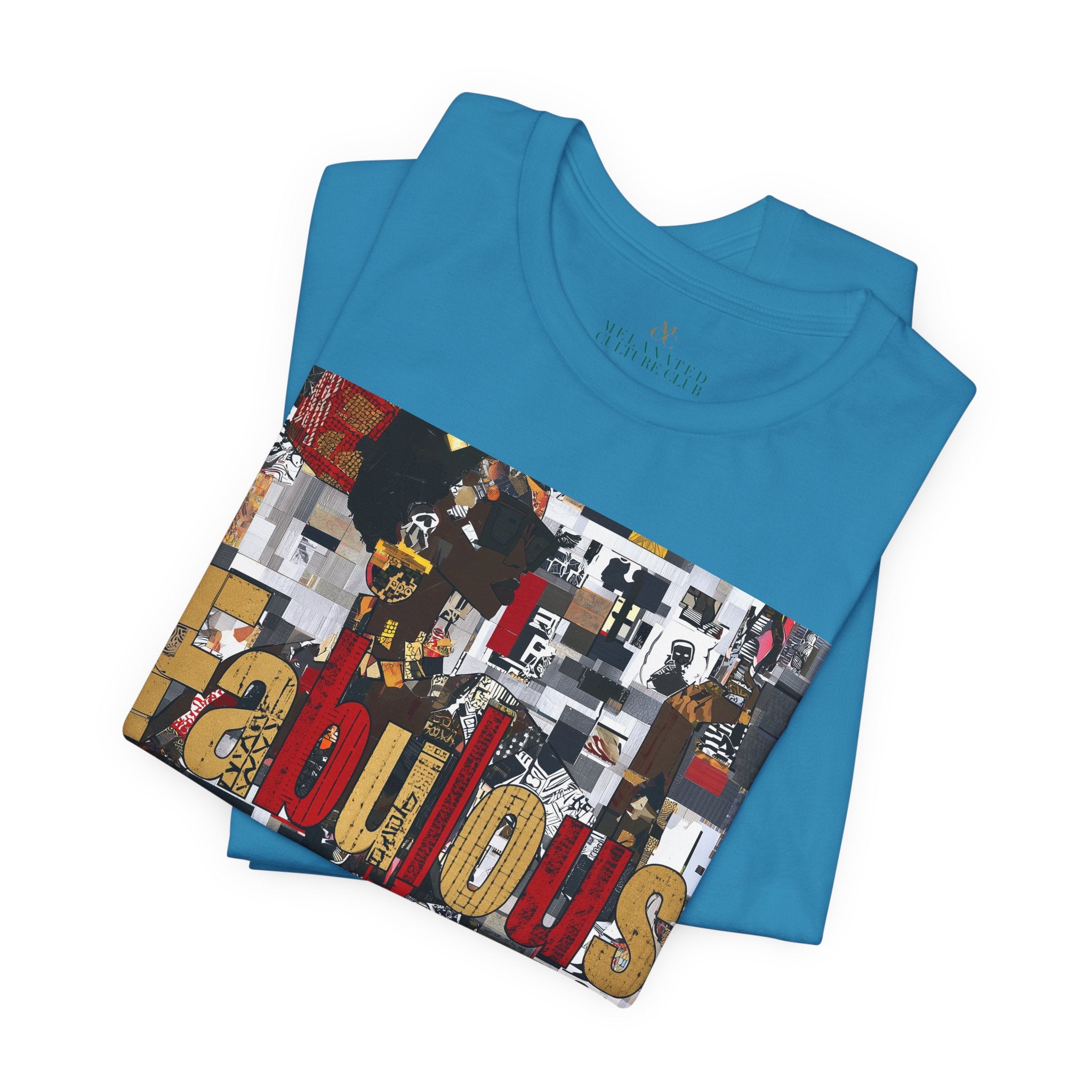A folded bright blue short-sleeve crewneck t-shirt featuring a large rectangular graphic print on the front with the word 'Fabulous' in gold letters over a collage of images featuring a stylized Black female.