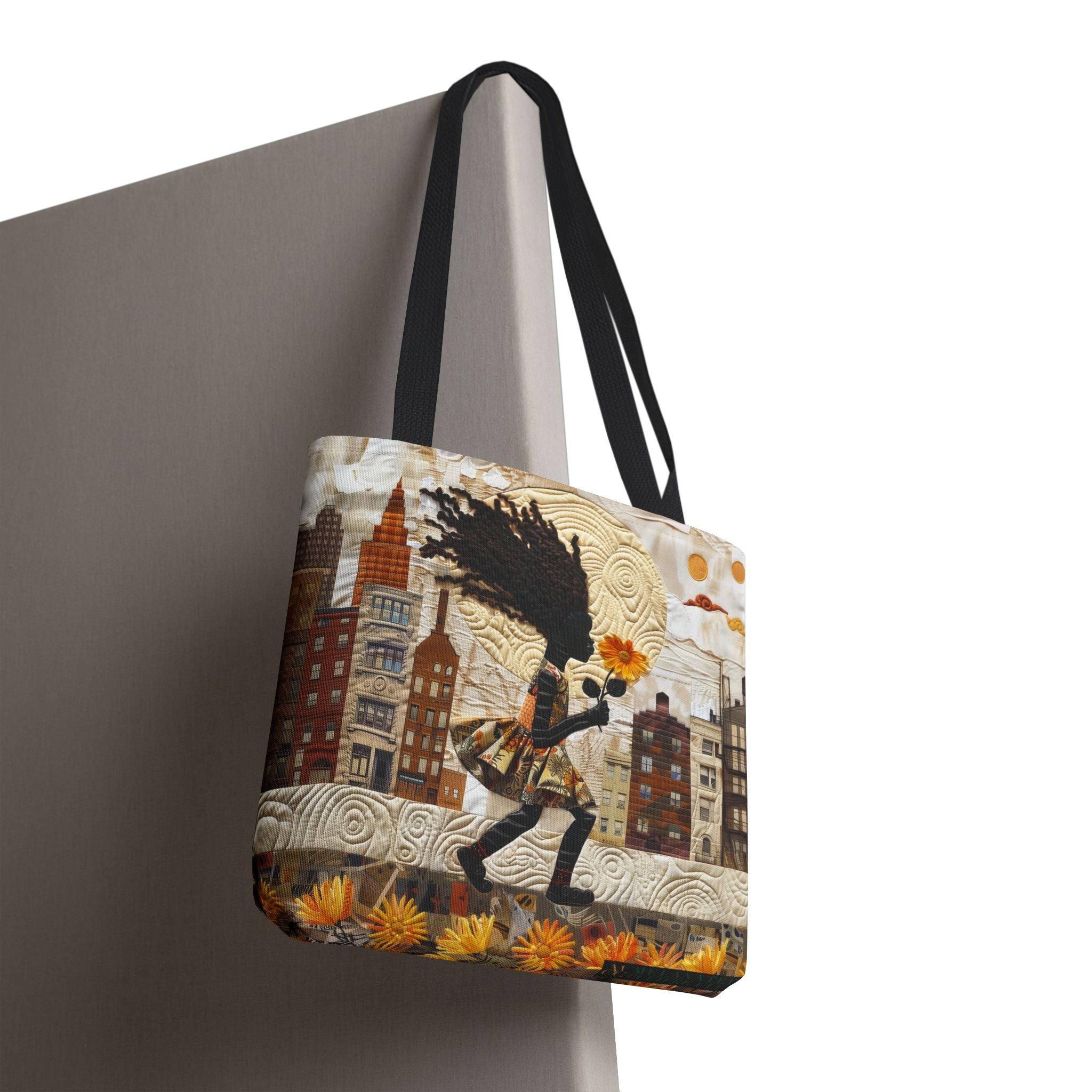 An Afrocentric faux quilt collage tote bag with a textured 3D-inspired design featuring a young Black girl carrying a bright yellow sunflower while walking through Harlem with long braids blowing in the wind. Historic Harlem brownstones and New York City architecture appear in the background on