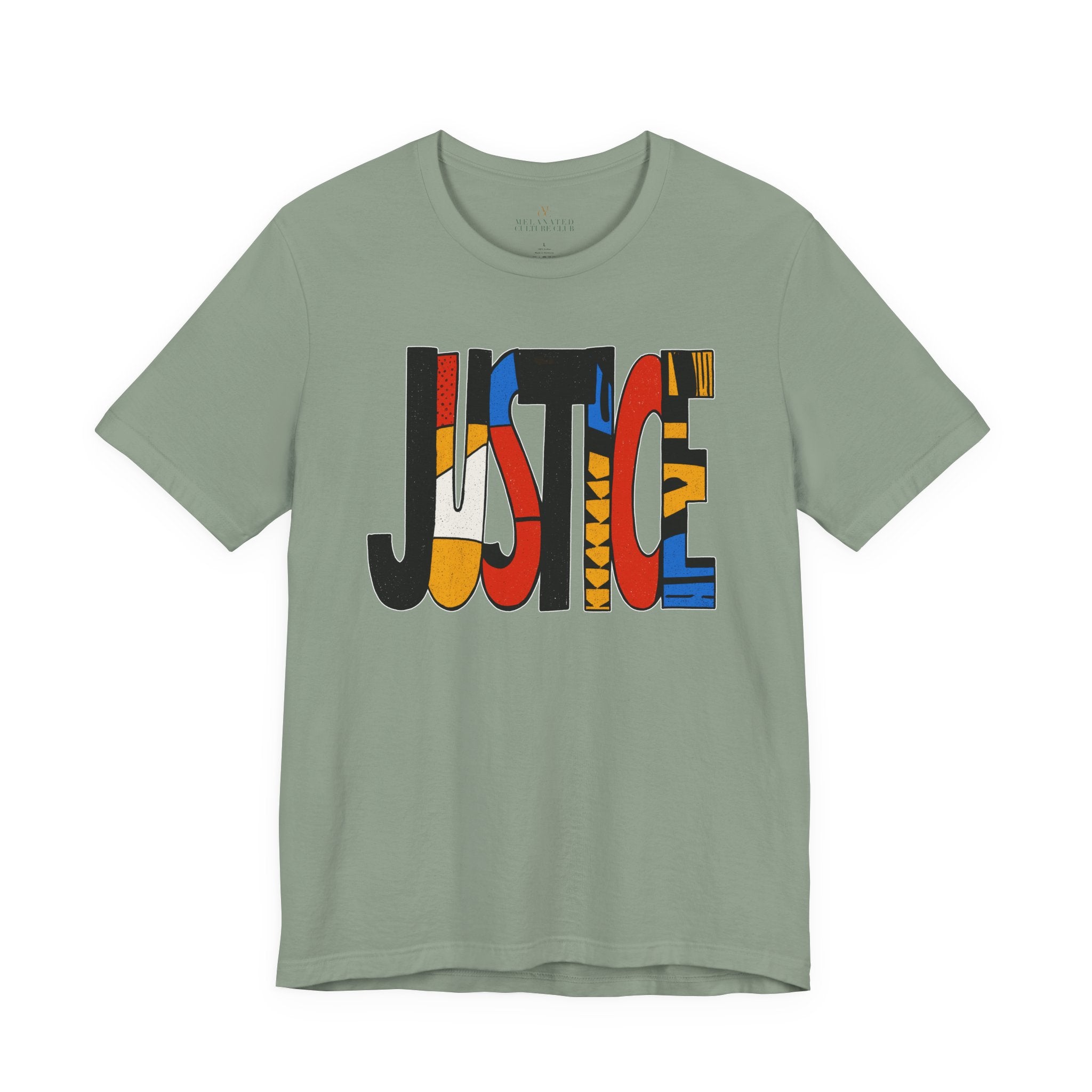 A sage green crewneck t-shirt featuring a large graphic print on the front spelling 'JUSTICE' in bold, multi-colored geometric patterns, shown against a plain white background.