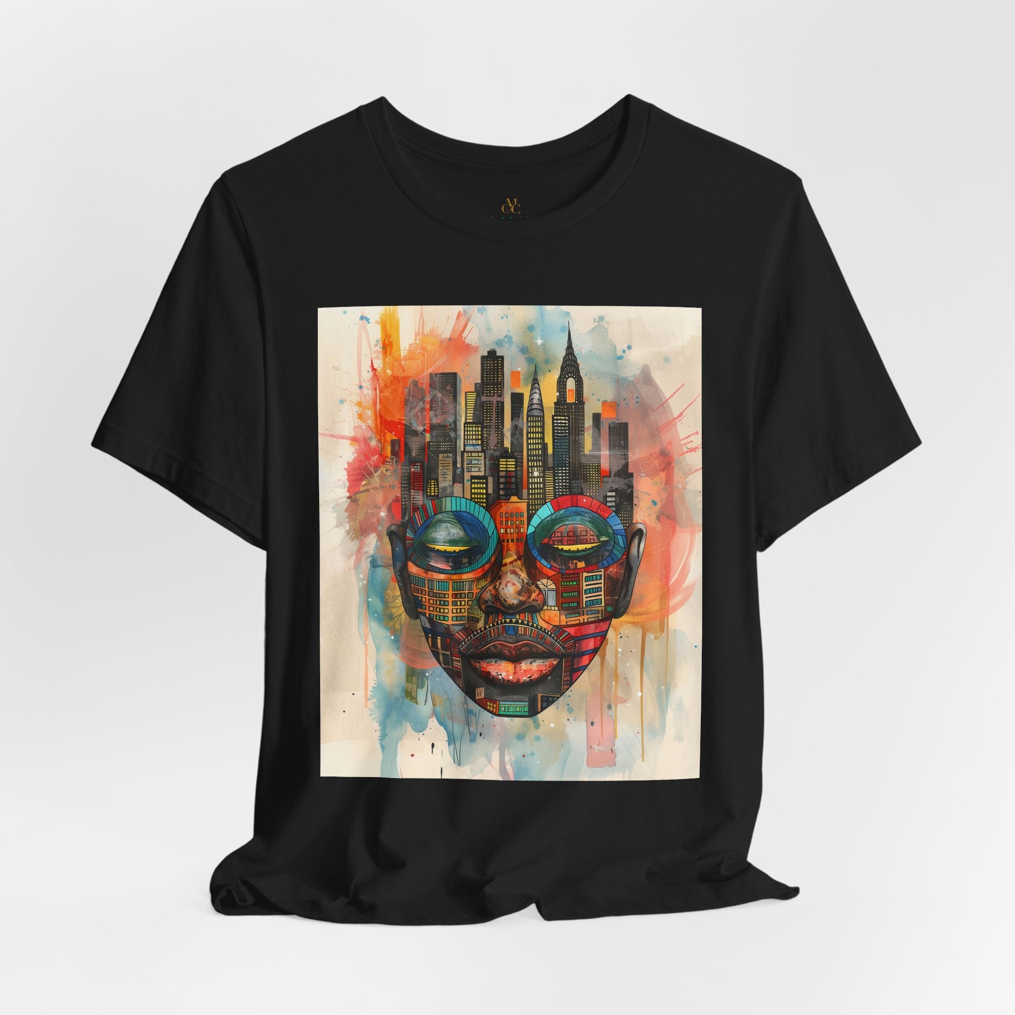 Afrocentric graphic t-shirt featuring an abstract African mask blended with the New York City skyline in a colorful watercolor style design celebrating Black culture and NYC pride.
