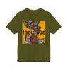 A olive green short-sleeve t-shirt featuring an Afrocentric Black woman with a large graphic print on the front with the word 'fabulous' in dark brown text over a collage of colorful objects.