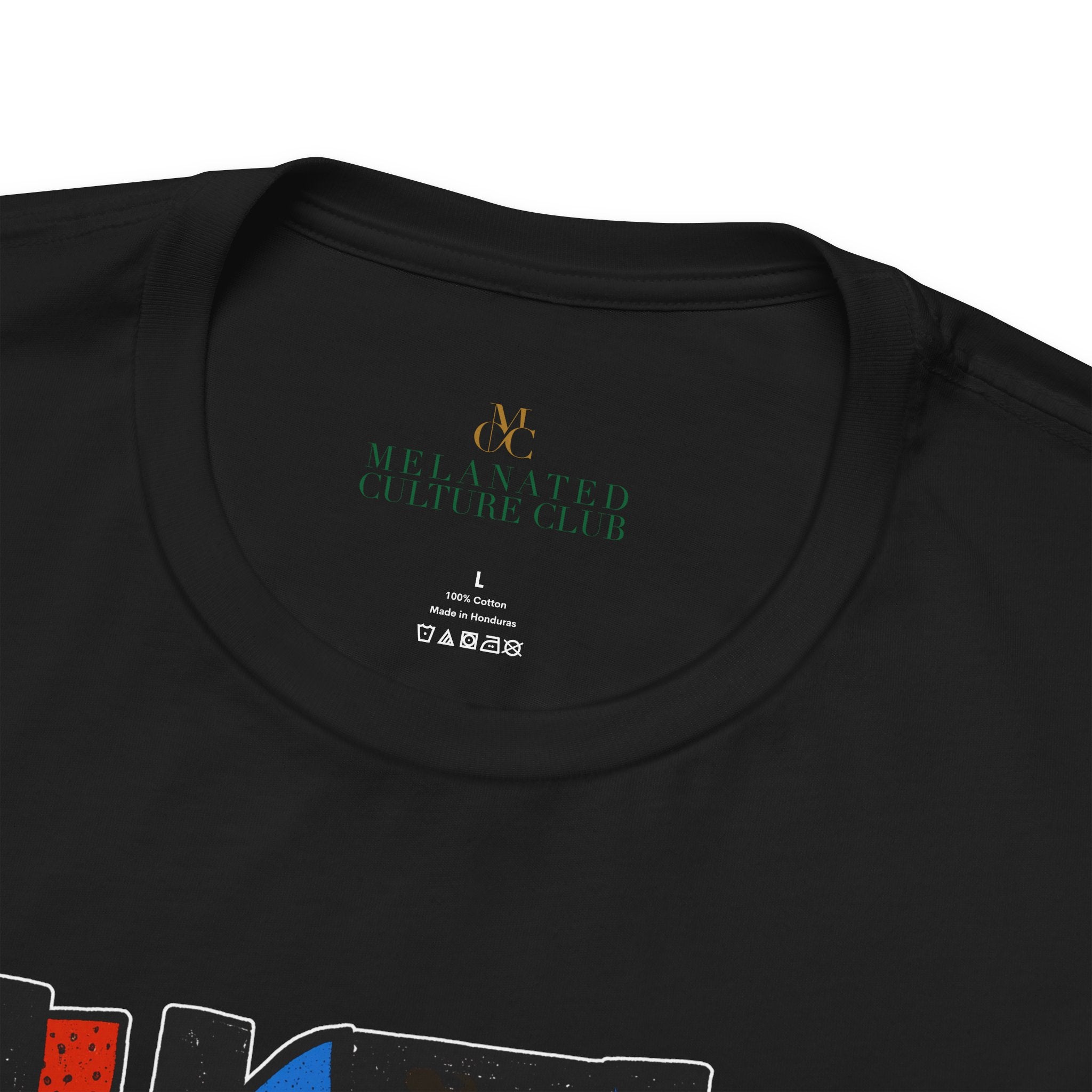 Close-up of the inside collar of a black t-shirt, showing the printed neck label for 'Melanated Culture Club' in green and gold, with size 'L' and care instructions below.