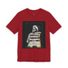 Afrocentric graphic tee shirt featuring a peaceful Black woman embracing a stack of books, symbolizing education, knowledge, freedom, and generational legacy.