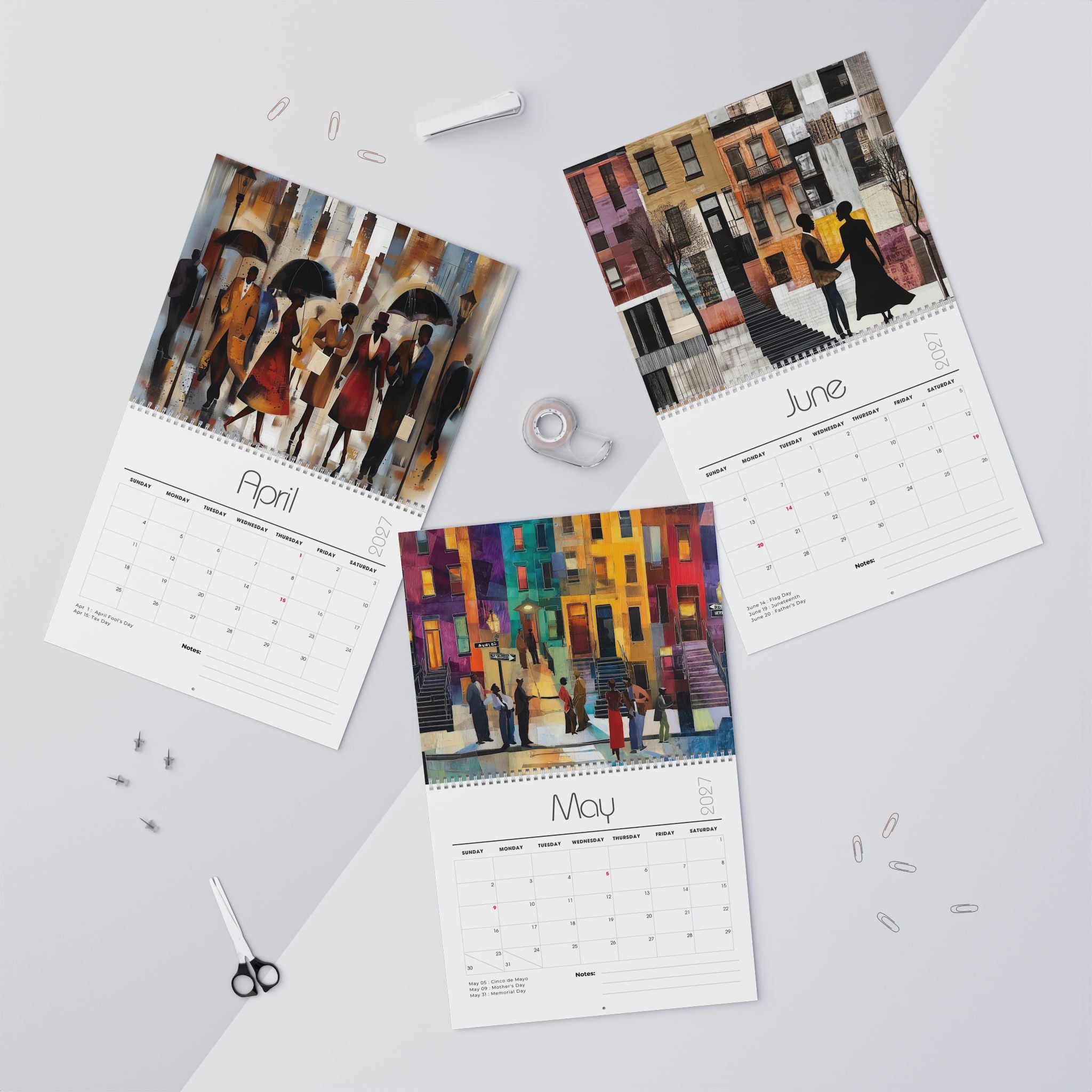 Three spiral-bound monthly calendars laid out on a light gray surface, each showing a colorful painted Harlem city street scene son the cover and a calendar grid page below. The visible months are April, May and June.