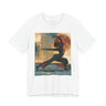 A white short-sleeve crewneck t-shirt featuring a Black woman in a yoga pose against a warm, abstract sunset background.