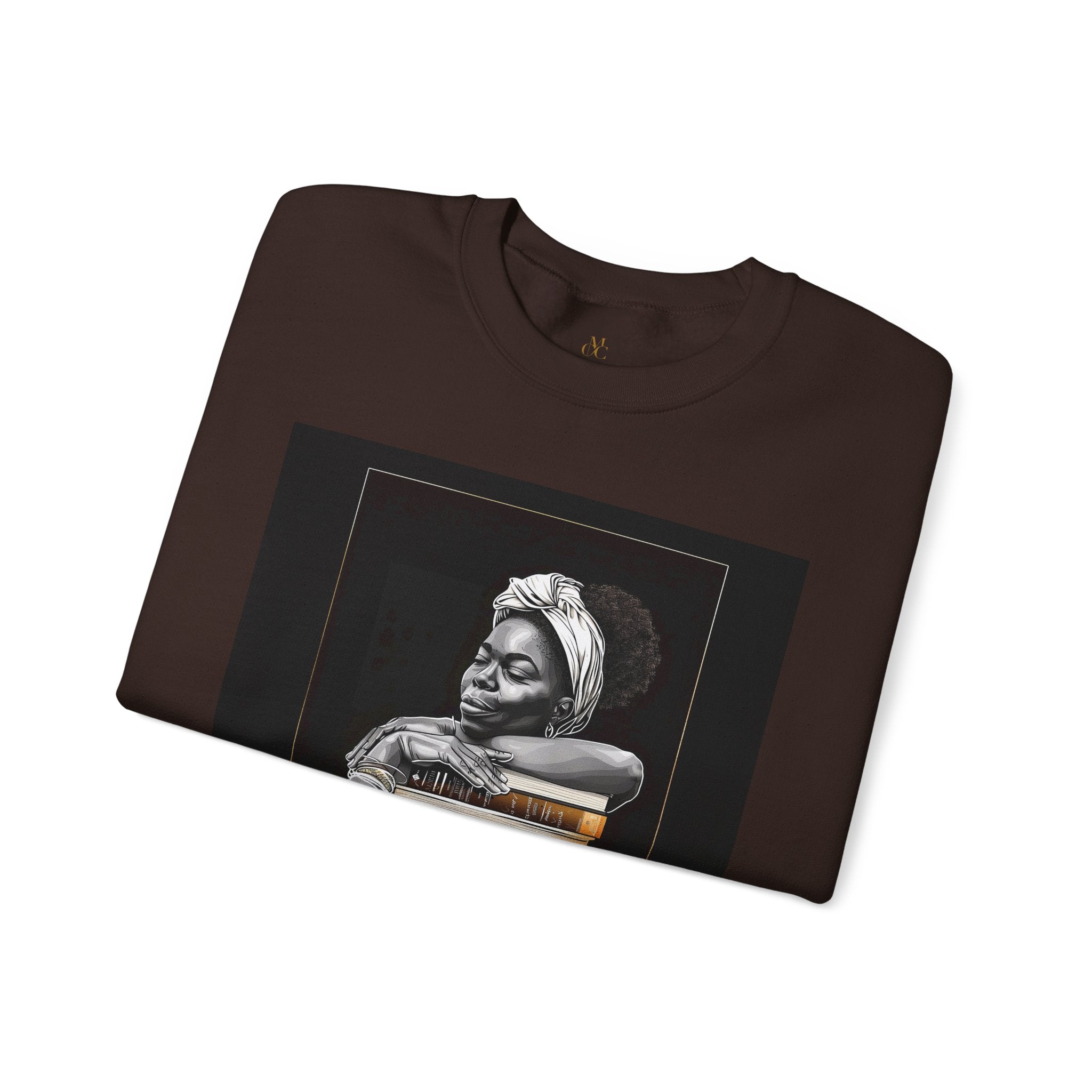 Afrocentric unisex sweatshirt featuring a Black woman embracing books. Cozy crewneck celebrating education, knowledge, freedom, and generational legacy.