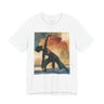 A white short-sleeve crewneck t-shirt featuring a Black woman in a yoga pose against a warm, abstract sunset background.