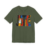 An olive green short-sleeve t-shirt with a large graphic on the chest spelling 'JUSTICE' in stacked, colorful geometric blocks of black, red, orange, yellow, and blue, shown against a plain white background.