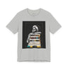 Afrocentric graphic tee shirt featuring a peaceful Black woman embracing a stack of books, symbolizing education, knowledge, freedom, and generational legacy.