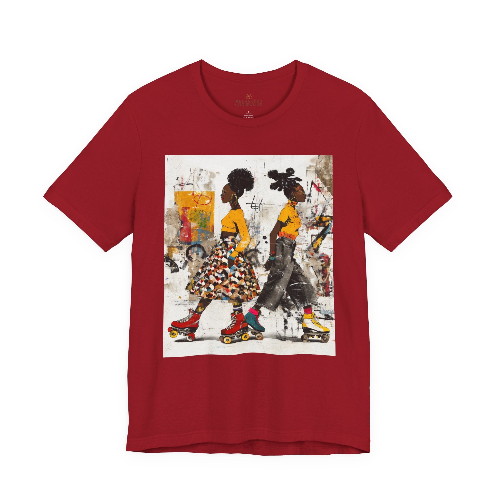 Two Black women with natural hairstyles wearing bold streetwear and roller skates, standing against a colorful abstract graffiti background on an Afrocentric graphic t-shirt.