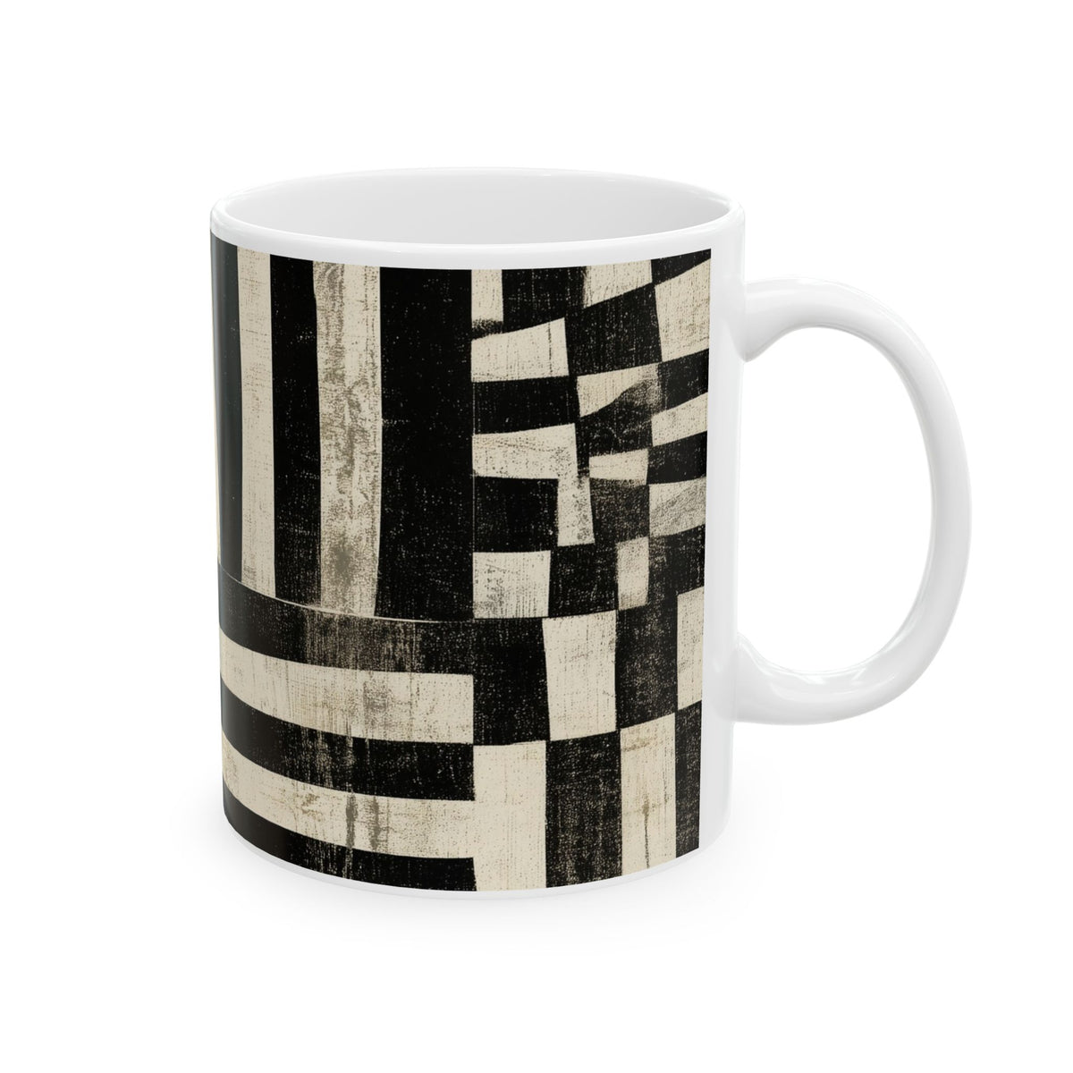 A white ceramic mug featuring a black and cream abstract geometric pattern with textured stripes and blocks, shown on a clean white background.