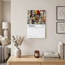 A wall-mounted 2027 January calendar featuring a colorful collage portrait of a Black female with glasses, displayed in a styled living room above a wooden console table with books, a candle, and a vase. Size 11" x 8.5"