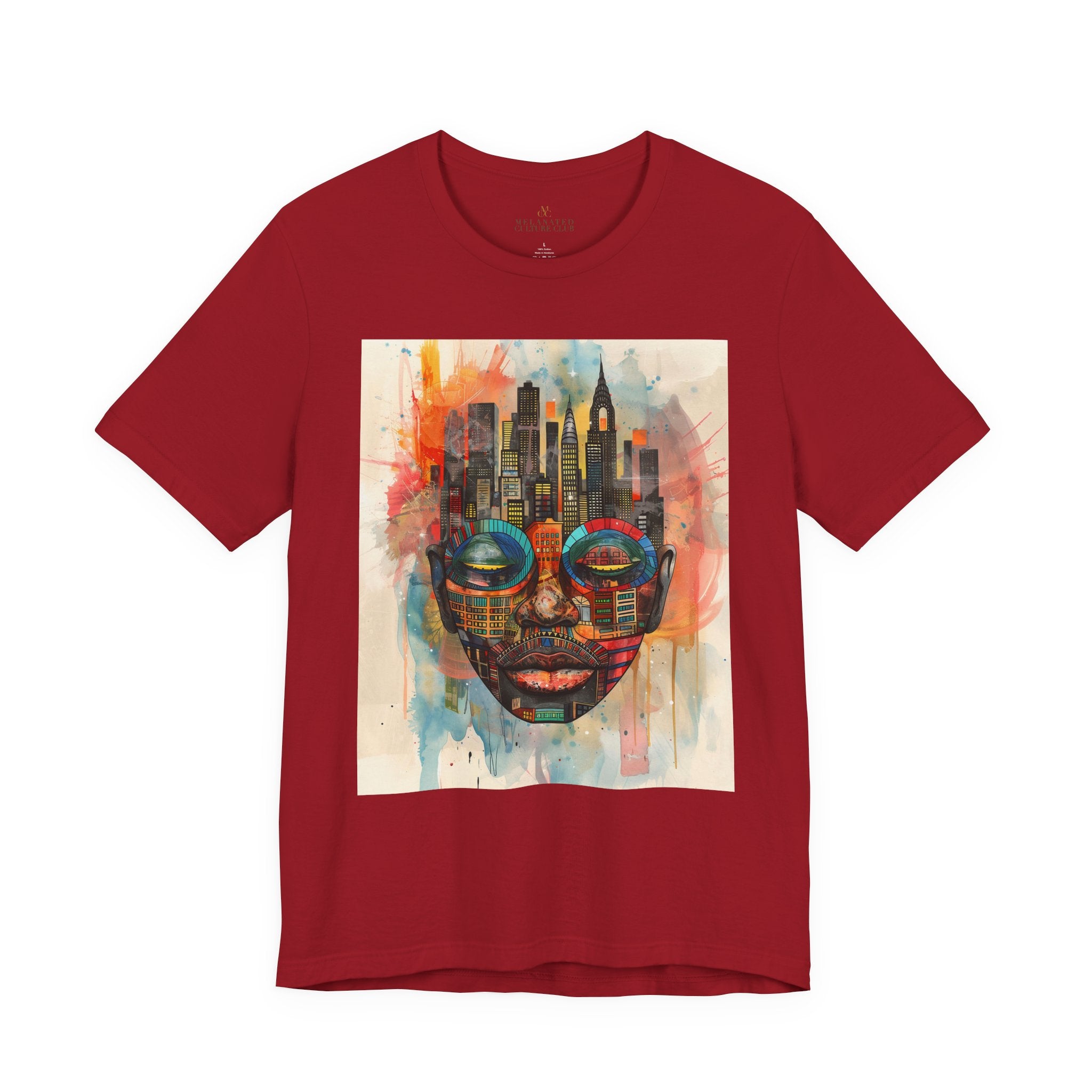 Afrocentric graphic t-shirt featuring an abstract African mask blended with the New York City skyline in a colorful watercolor style design celebrating Black culture and NYC pride.