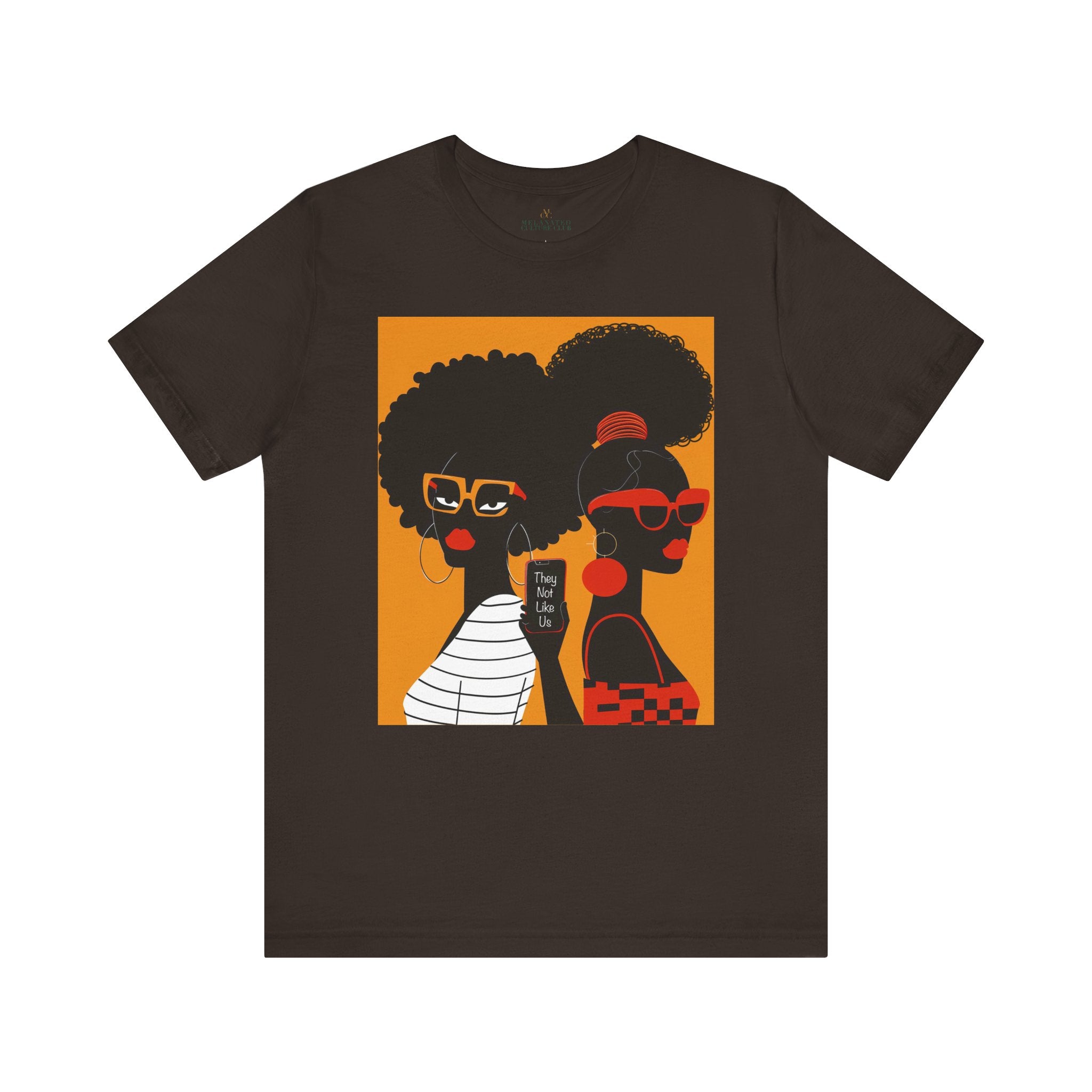 They Not Like Us Tee Shirt featuring two Black women in silhouette wearing high-fashion eyewear, holding a cell phone with the phrase "They Not Like Us" on an orange background – Afrocentric unisex apparel.