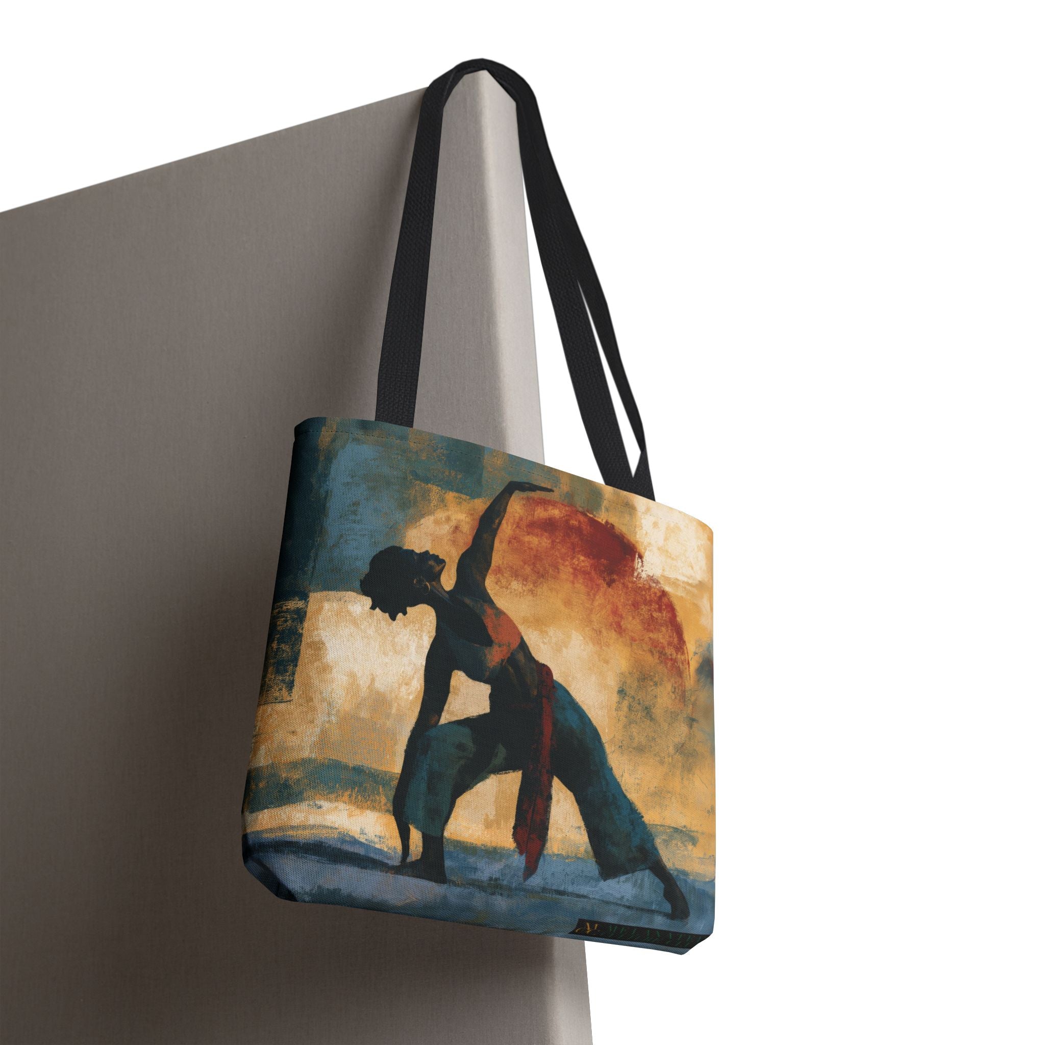 A canvas tote bag with black shoulder straps, featuring a printed artistic illustration of a black woman in a yoga pose against a warm sunset background.