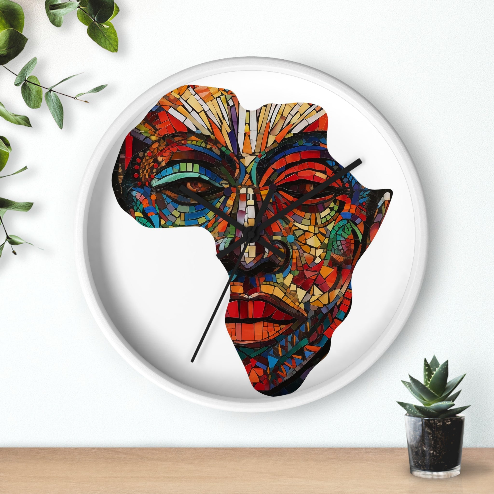 White round wall clock featuring a digitally-generated African mask in the shape of the map of Africa.