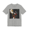 A heather gray short-sleeve crewneck t-shirt featuring a square graphic print of an abstract portrait of a Black woman with a large afro, gold hoop earrings, and red lipstick on a black background.