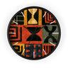 Black Afrocentric abstract geometric round wall clock with white time markings and black clock hands, featuring African-inspired symbols, spirals, arches, stripes, and graphic patterns in red, black, mustard gold, charcoal, and earthy gray, displayed against a white background.