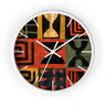 White Afrocentric abstract geometric round wall clock with white time markings and black clock hands, featuring African-inspired symbols, spirals, arches, stripes, and graphic patterns in red, black, mustard gold, charcoal, and earthy gray, displayed against a white background.