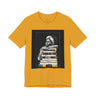 Afrocentric graphic tee shirt featuring a peaceful Black woman embracing a stack of books, symbolizing education, knowledge, freedom, and generational legacy.