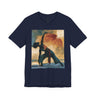 A navy colored short-sleeve crewneck t-shirt featuring a Black woman in a yoga pose against a warm, abstract sunset background.