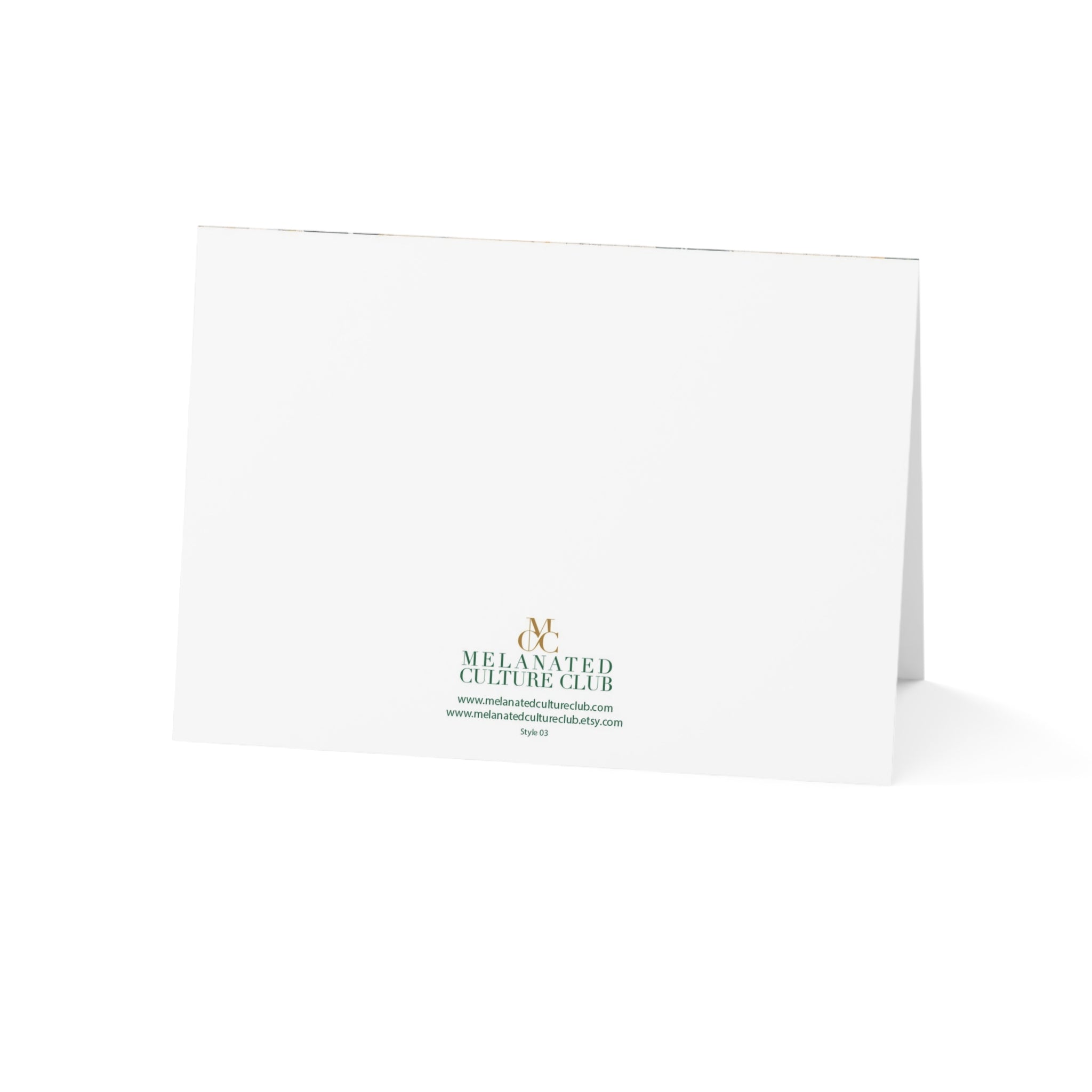 A white folded greeting card or invitation standing upright on a white background, printed with the Melanated Culture Club logo in green and gold near the bottom center.