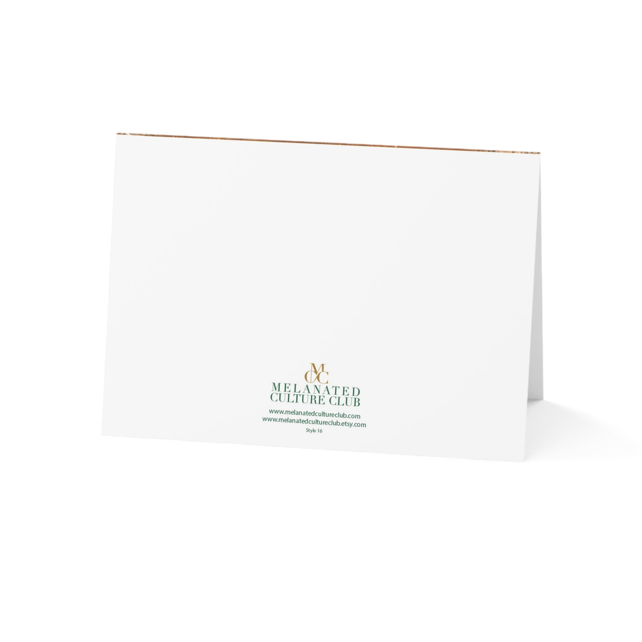 A white folded greeting card standing upright on a white background, printed with the Melanated Culture Club logo in green and gold near the bottom center.
