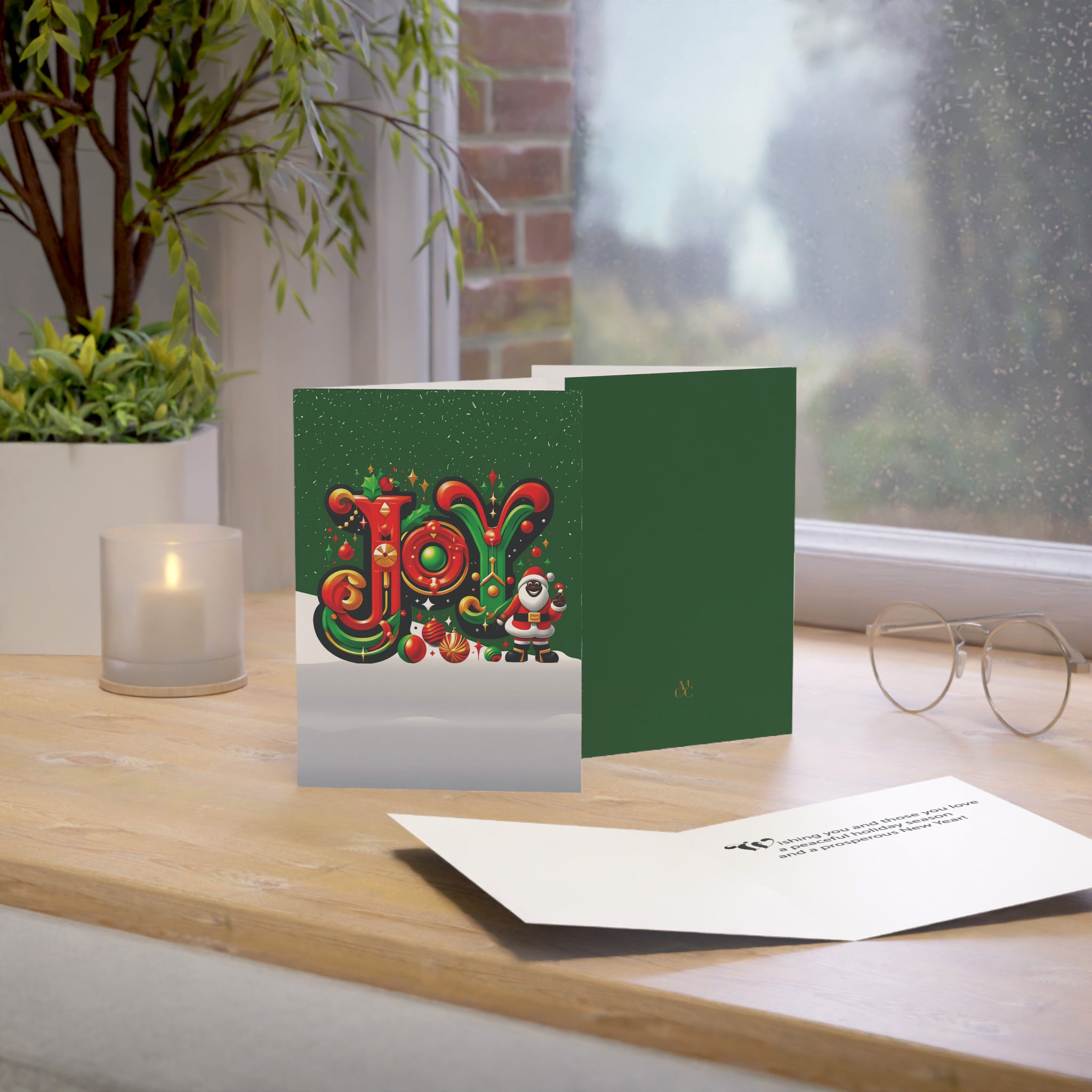 Black Santa Christmas Card featuring African American Santa Claus with the word “JOY,” Afrocentric holiday greeting card available as single or multipack with envelopes.