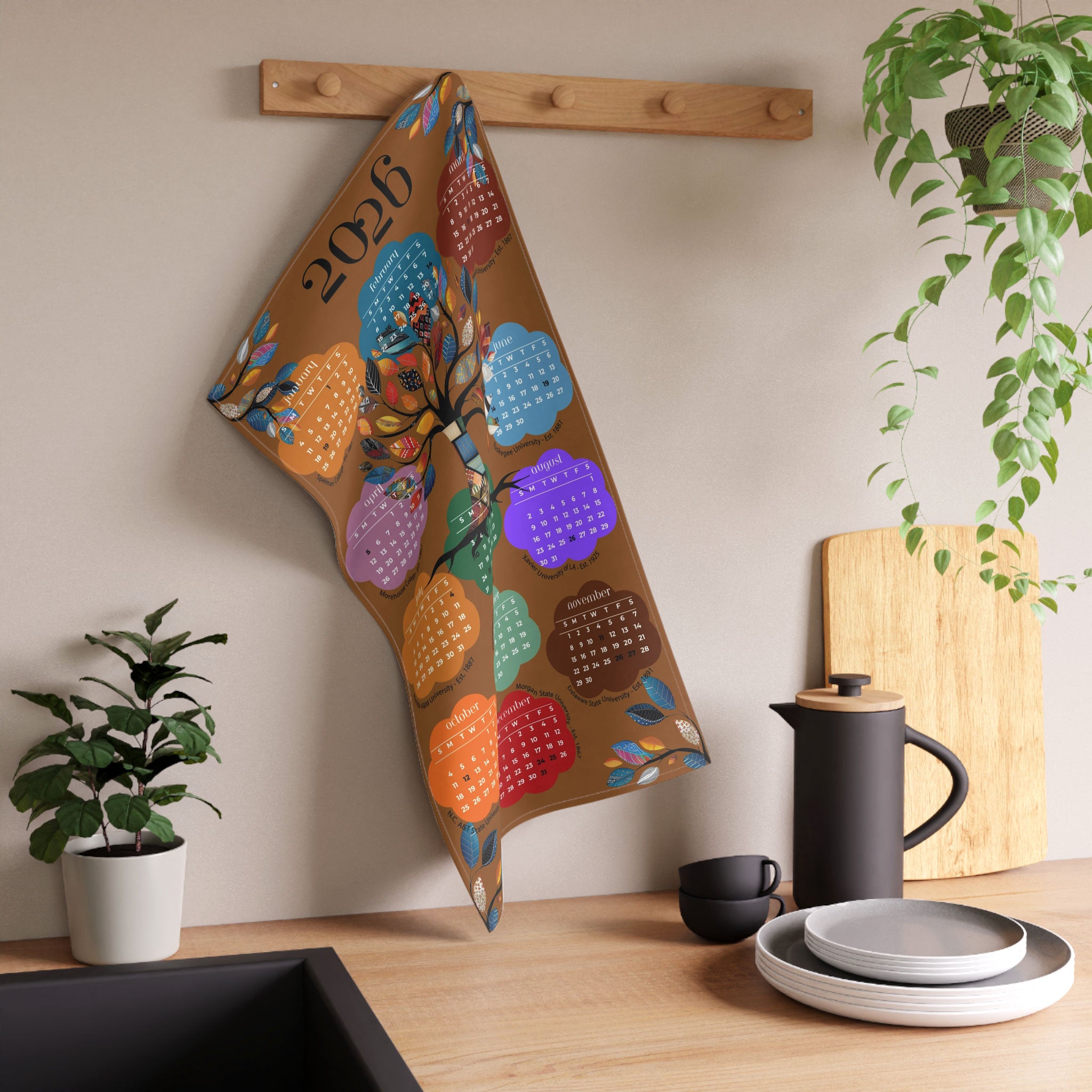 2026 Tea Towel Calendar featuring an abstract Tree of Life design with the names of the Top 10 HBCUs. Afrocentric kitchen decor and African American heritage gift.