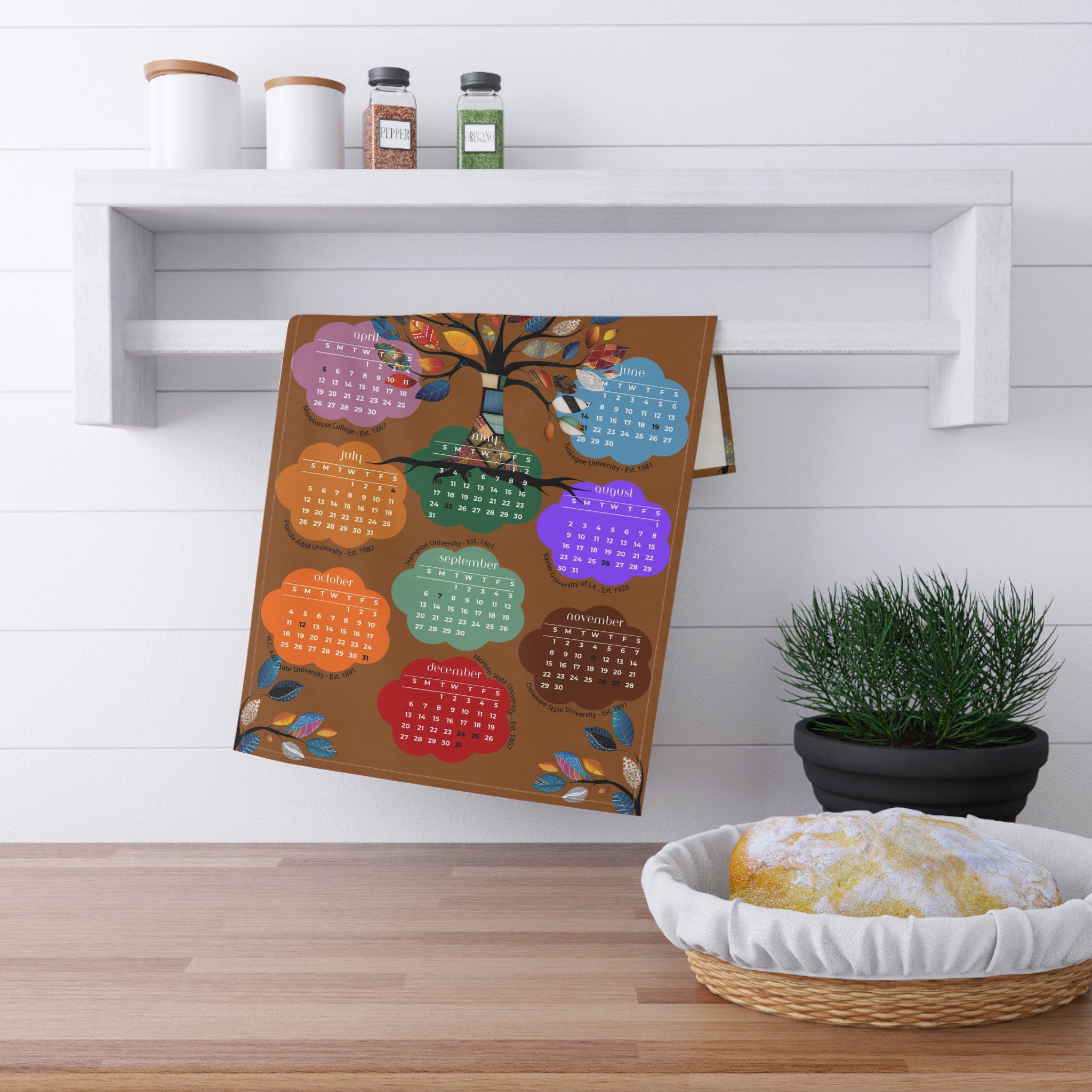 2026 Tea Towel Calendar featuring an abstract Tree of Life design with the names of the Top 10 HBCUs. Afrocentric kitchen decor and African American heritage gift.