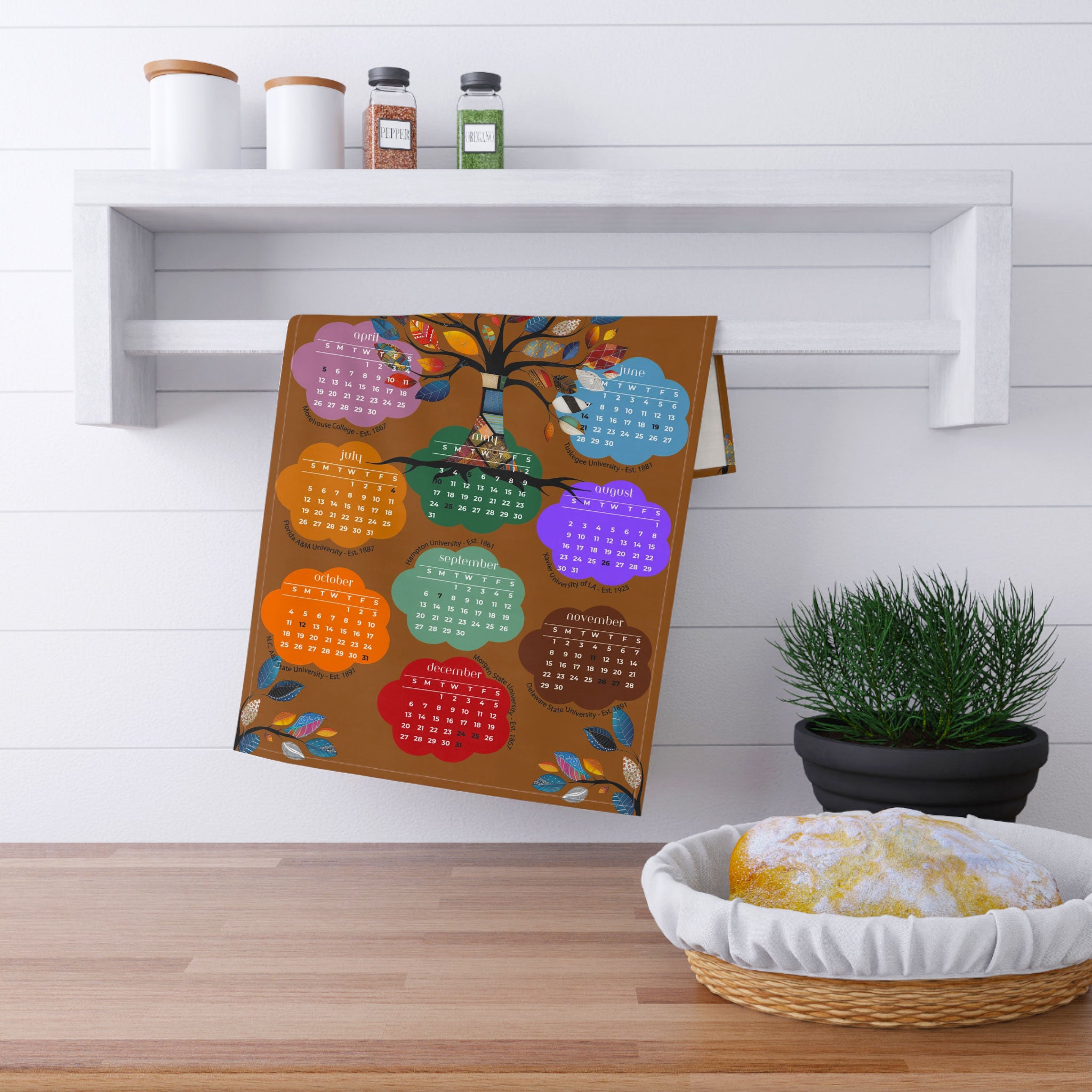 2026 Tea Towel Calendar featuring an abstract Tree of Life design with the names of the Top 10 HBCUs. Afrocentric kitchen decor and African American heritage gift.