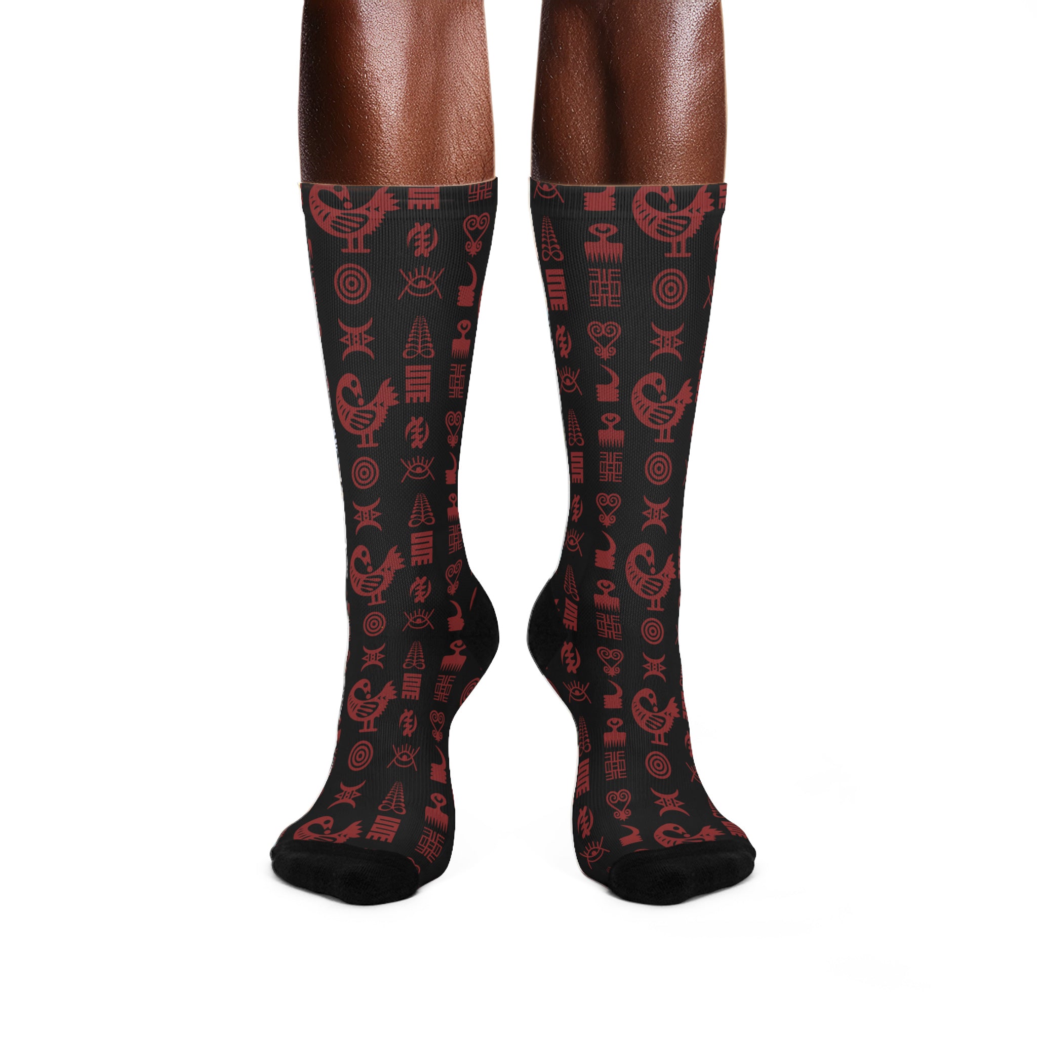 Crew socks featuring traditional Ghanaian Adinkra symbols in an Afrocentric pattern representing wisdom, strength, unity, perseverance, and African cultural heritage.