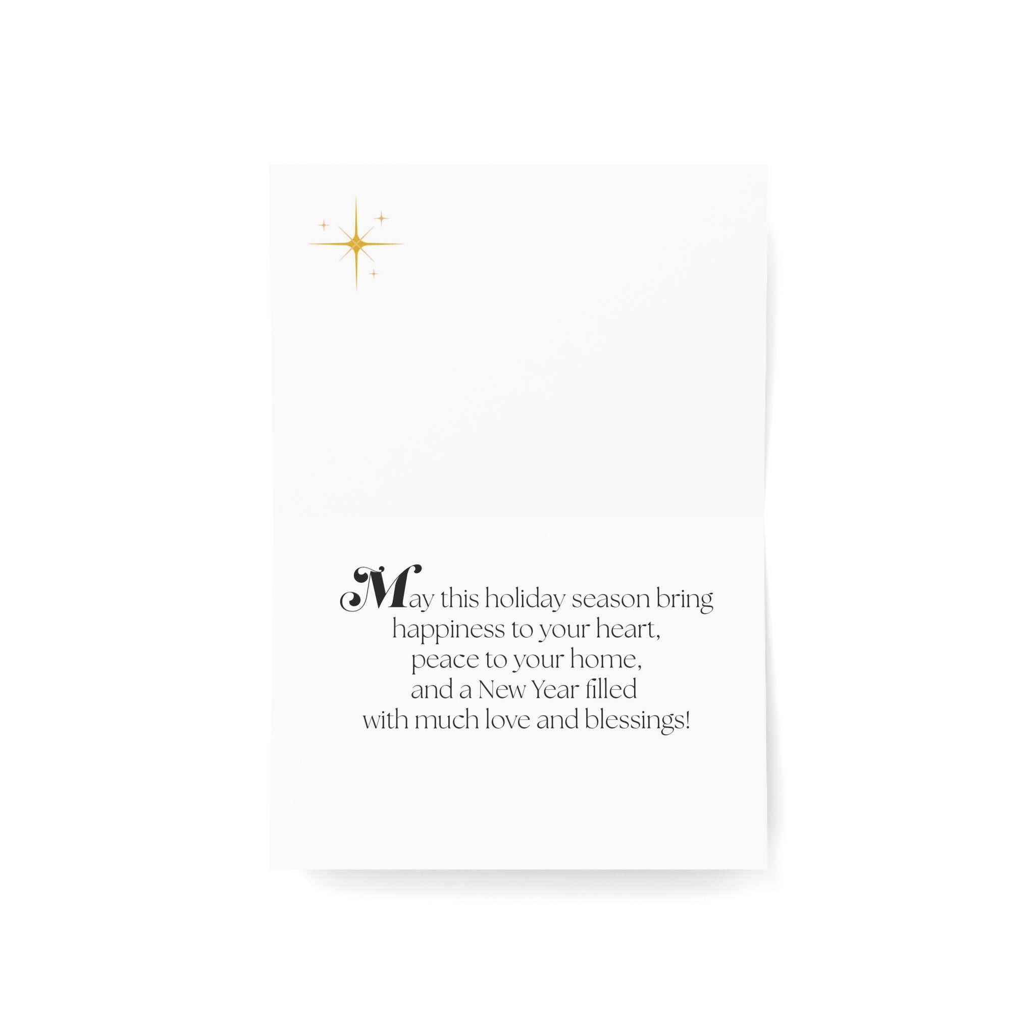 A vertical white greeting card with a small gold starburst in the upper left and a holiday message in the lower half, shown on a clean white background with a soft shadow.