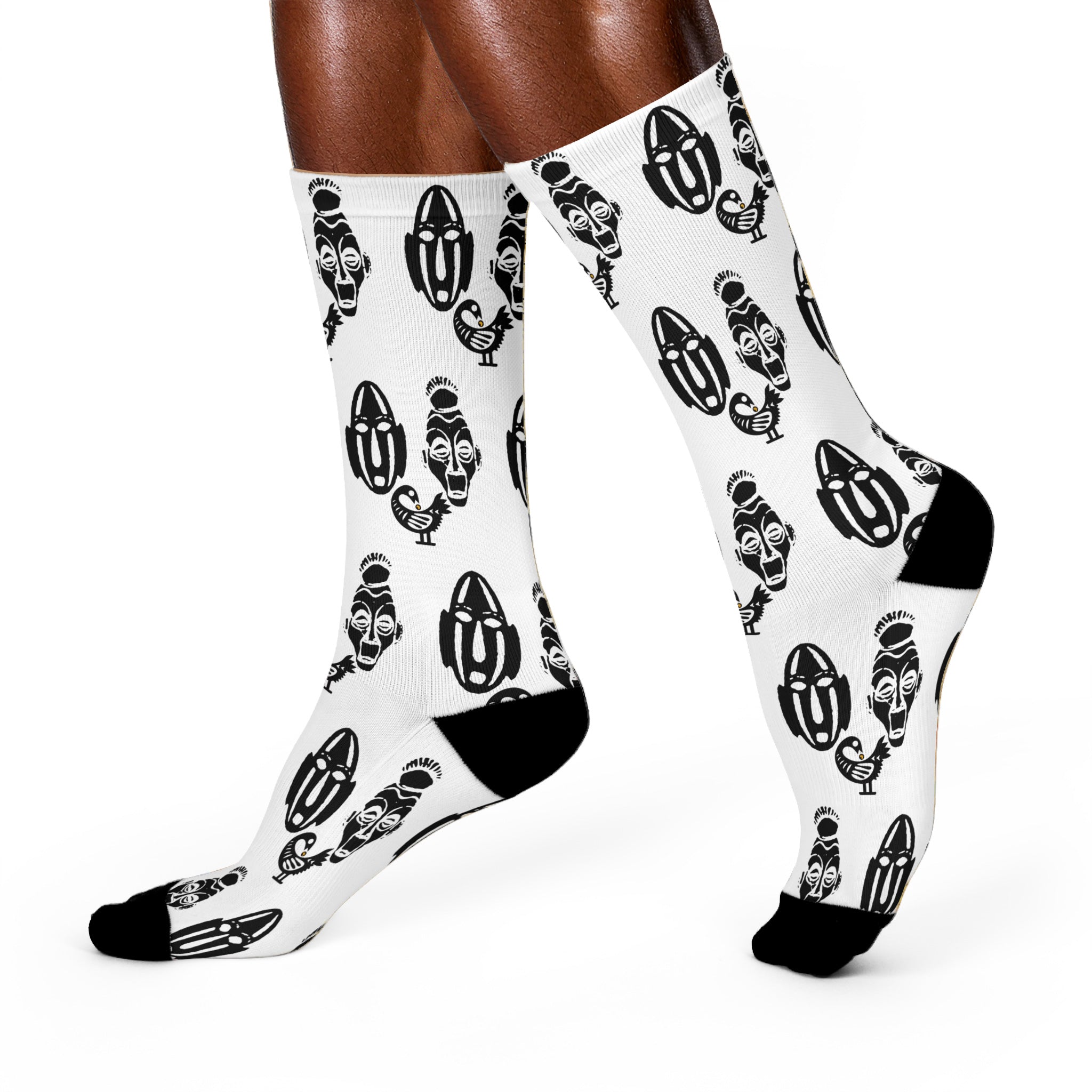 White crew socks featuring the Sankofa Adinkra bird symbol and two traditional African masks representing African heritage, cultural pride, and the meaning “Go Back and Get It.”