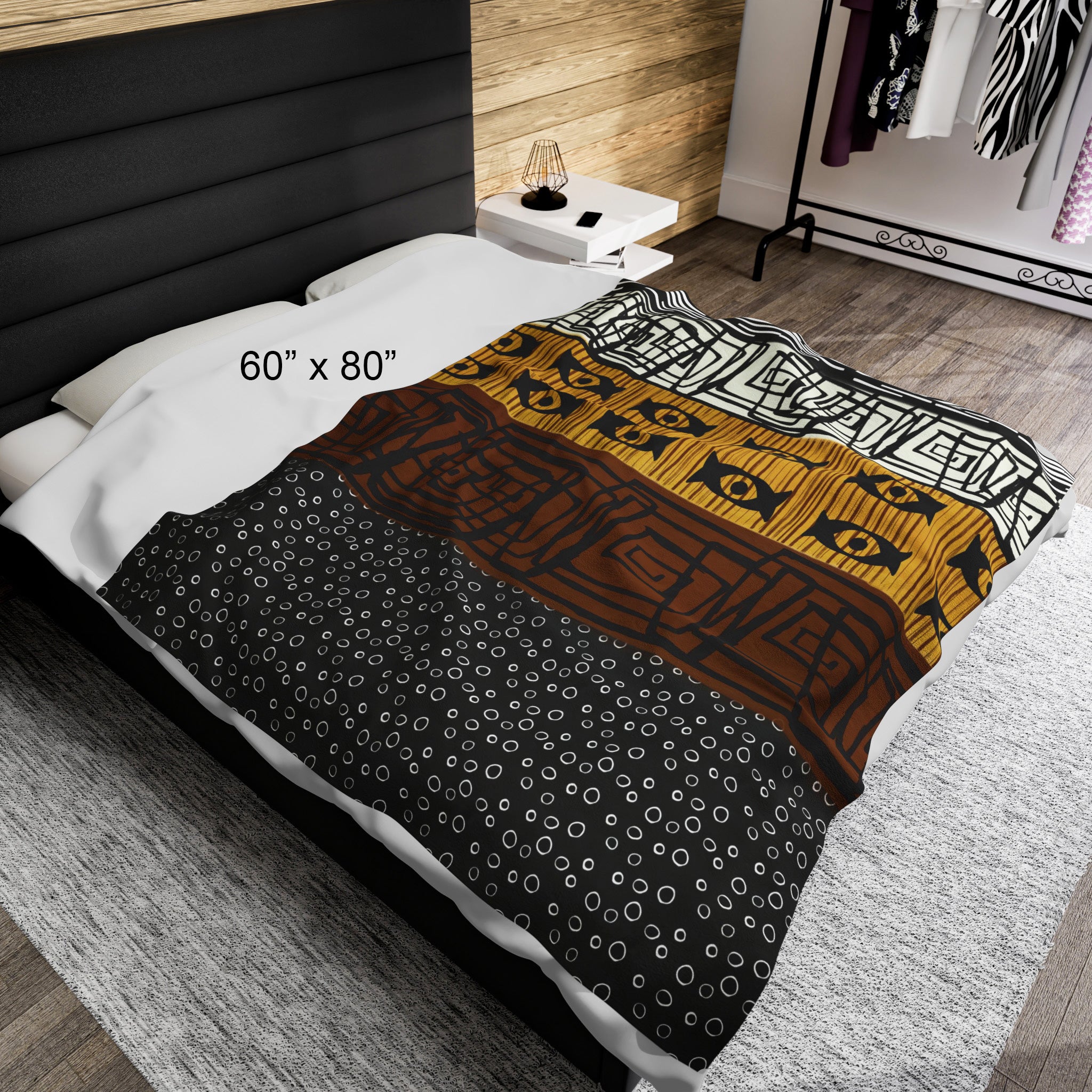 60"x80" African Print Velveteen Blanket laying horizontal on a full size bed..