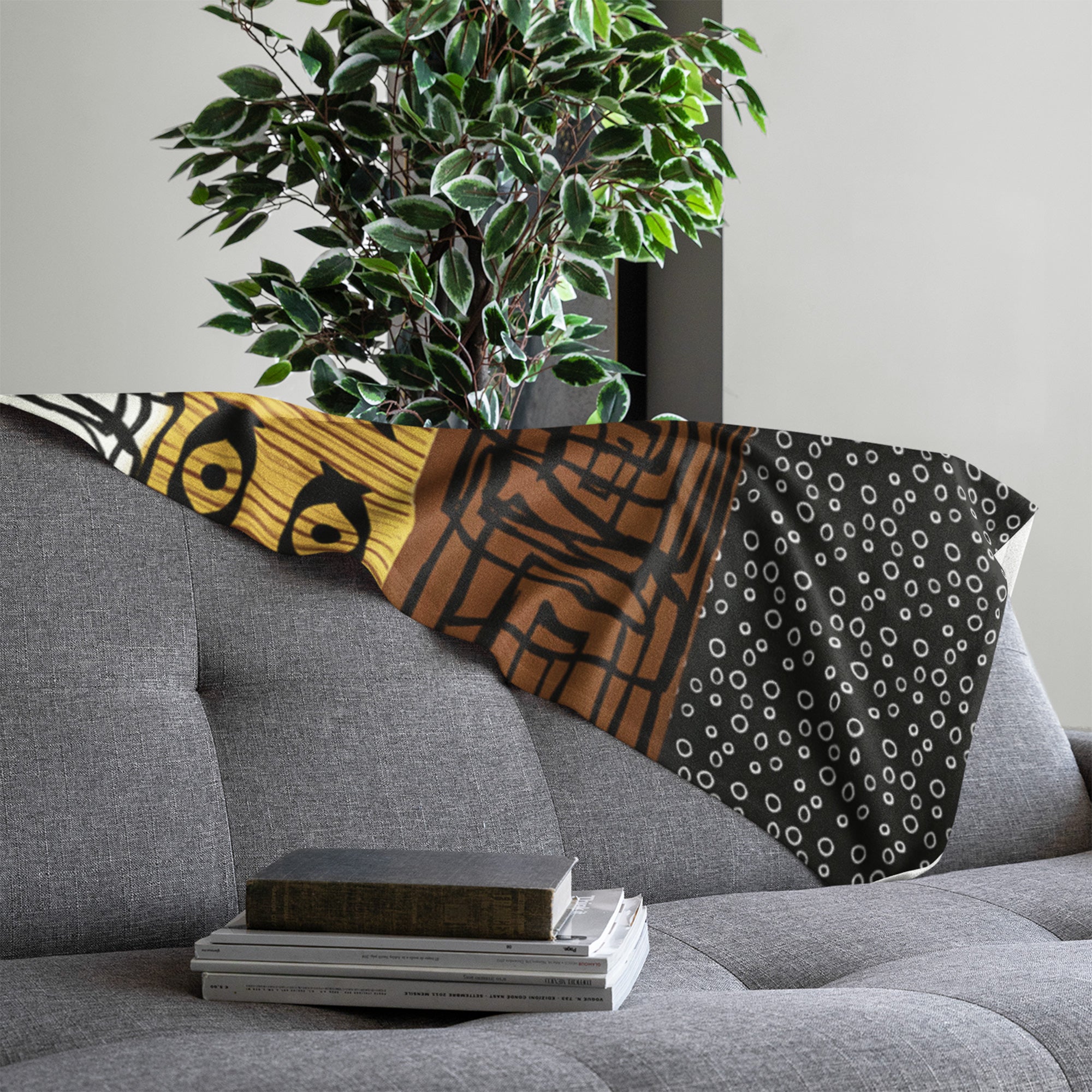 African Print Velveteen Blanket laying on the back of a sofa..