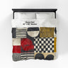 Full view of 60" x 80" Afrocentric geometric art throw blanket featuring bold black, red, gold, cream, and neutral abstract patterns with circles, spirals, grids, and textured African-inspired geometric shapes, laying over a queen size bed with white bed linen.
