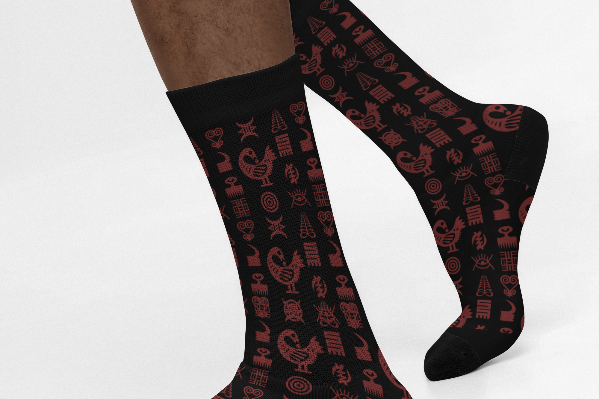 Crew socks featuring traditional Ghanaian Adinkra symbols in an Afrocentric pattern representing wisdom, strength, unity, perseverance, and African cultural heritage.