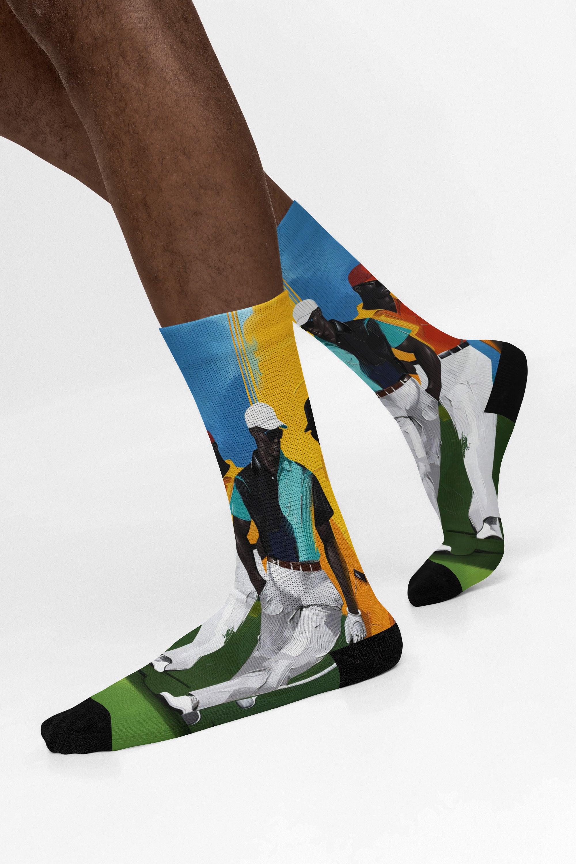 White crew socks featuring Afrocentric painterly artwork of Black men playing golf on a vibrant green course, celebrating Black joy, leisure, and stylish golf culture.